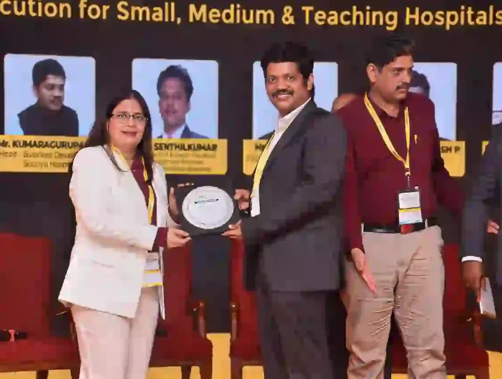 Healthcare professional receiving award at hospital management conference